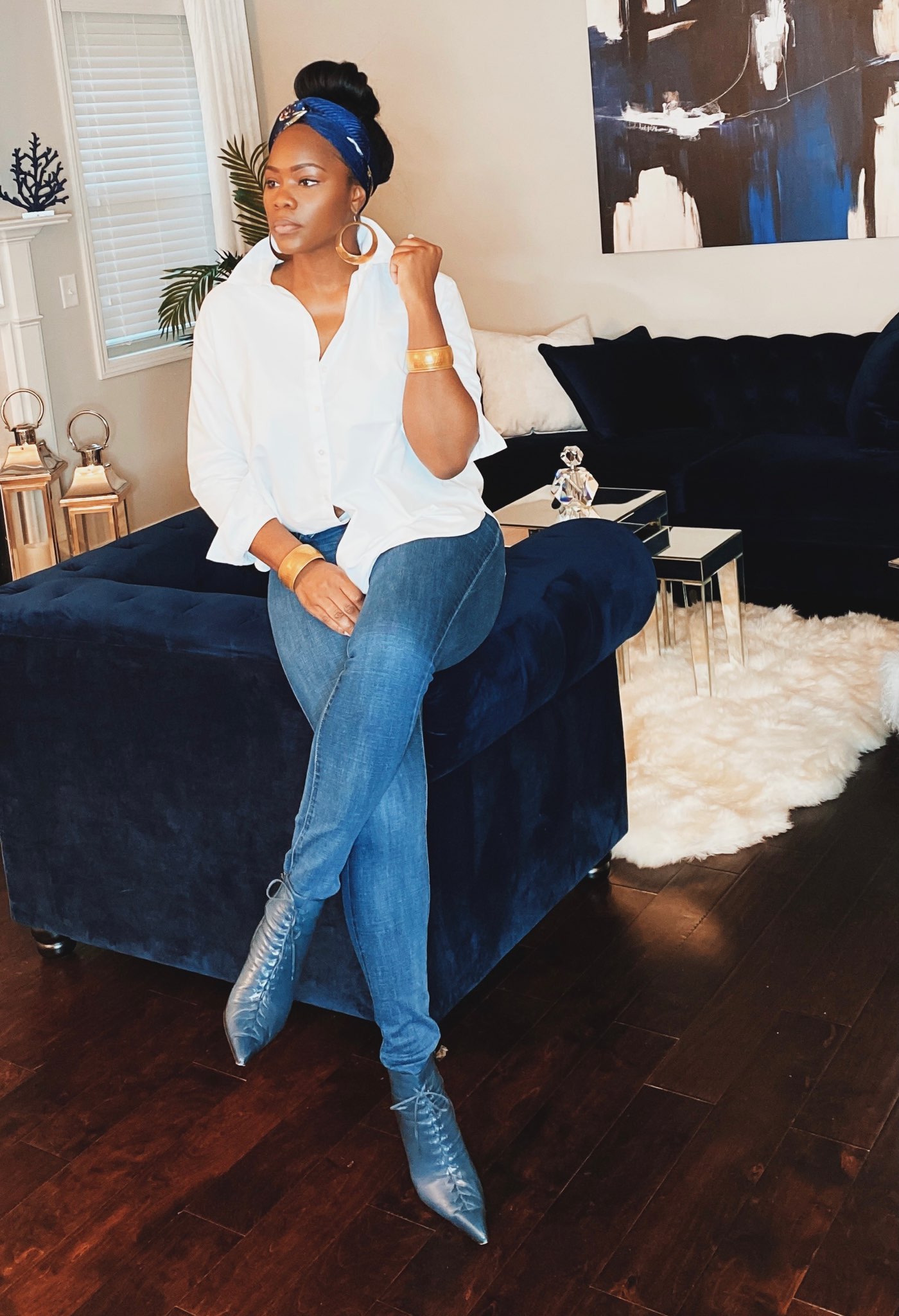 Blue booties with denim jeans and a classic white button up