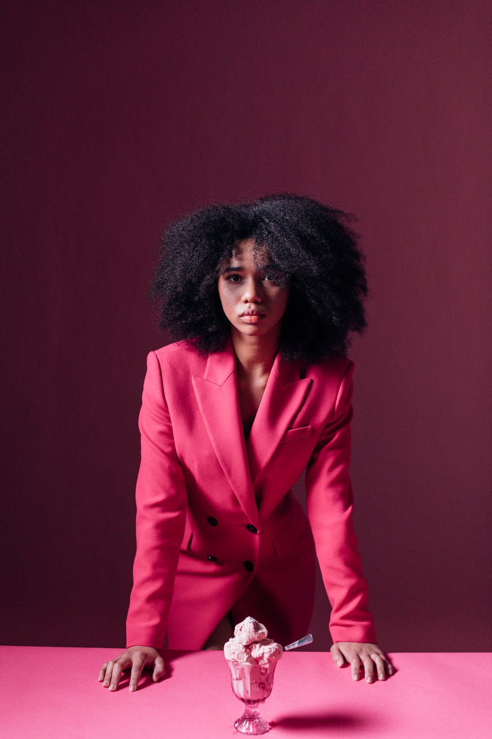 Woman with natural hair and a Pink work suit