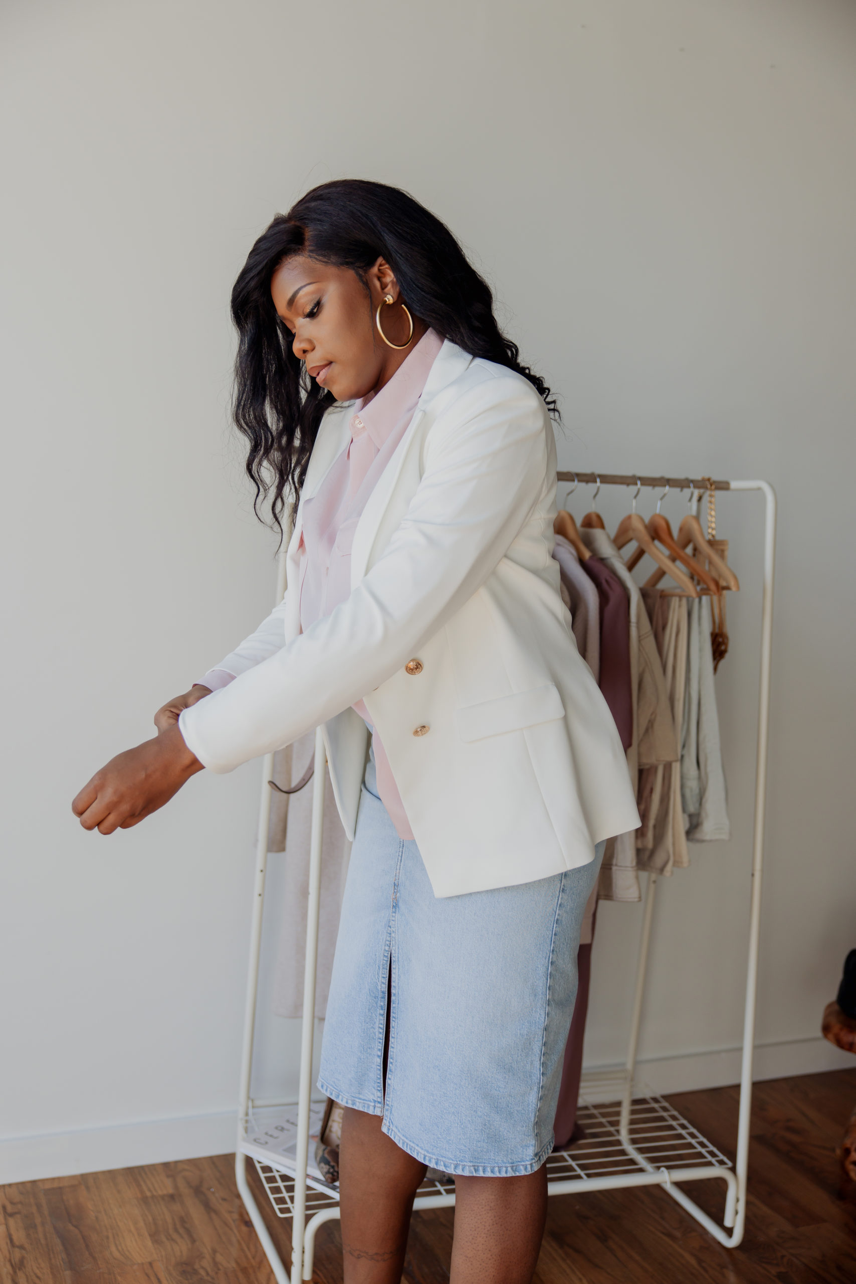 Ivory calving klein blazer with a light pink button up top and a denim skirt