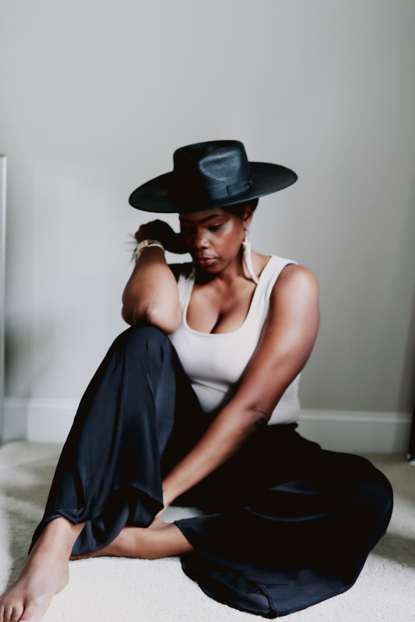 Black straw hat with an Zars tank top and satin palazzo pant