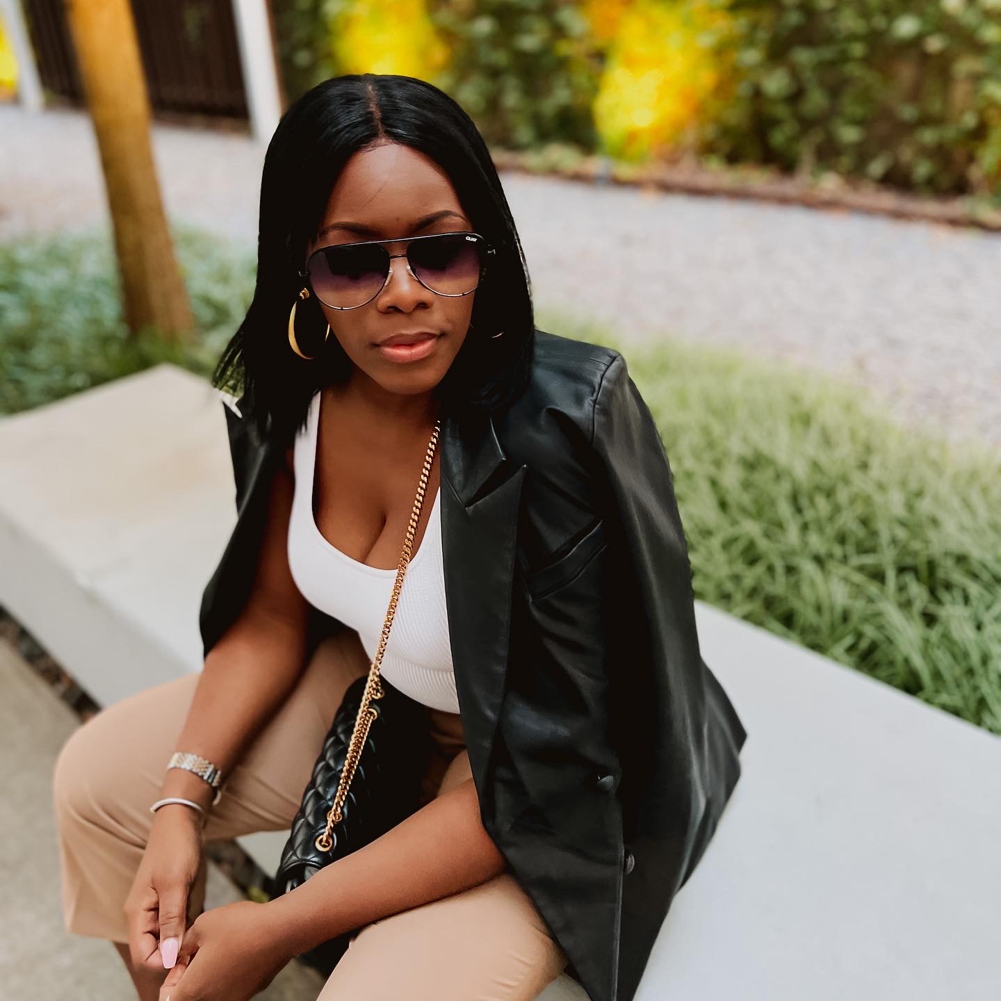 Black leather cropped leather with a white tank and khaki pants