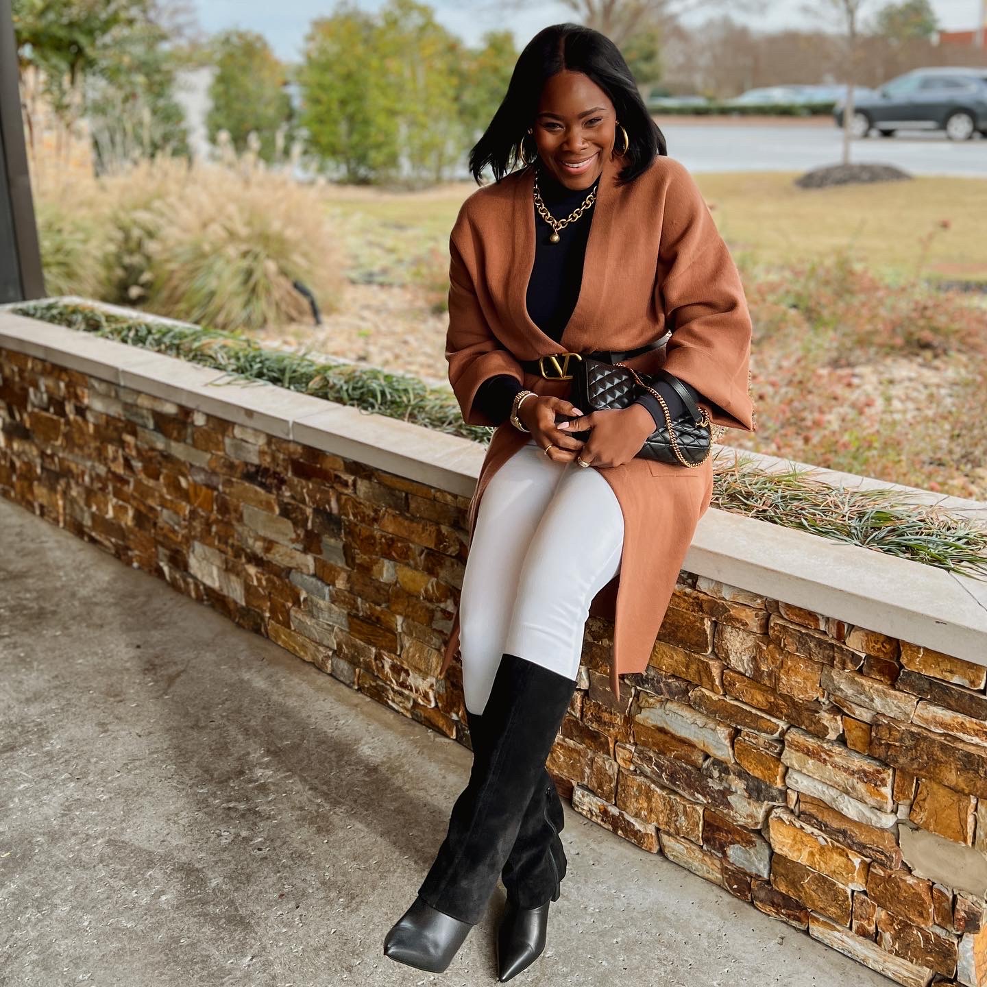 Brown cardigan with white pants and black boots