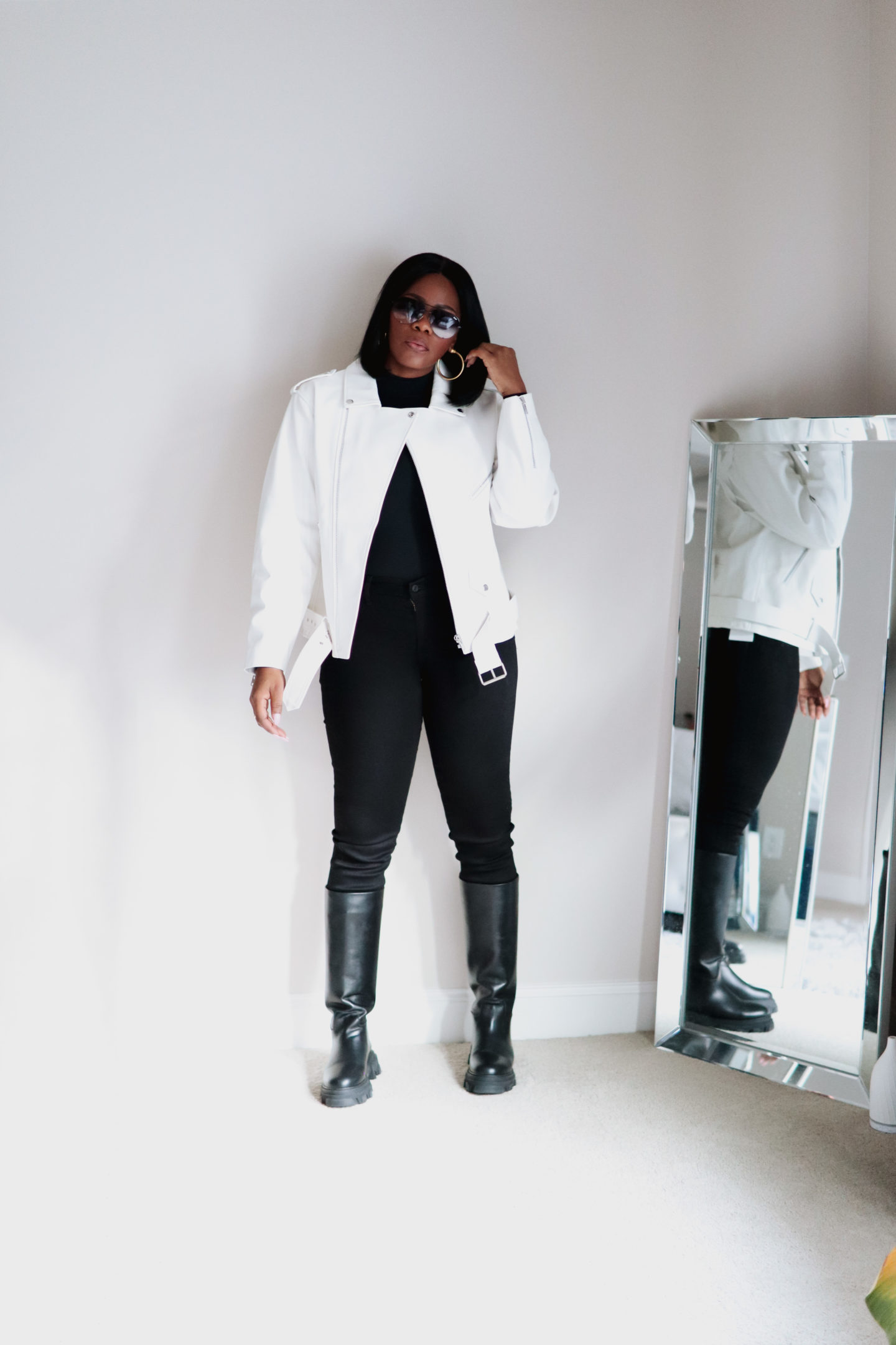 Chunky calf boots with black on black outfit, with a white leather moto jacket