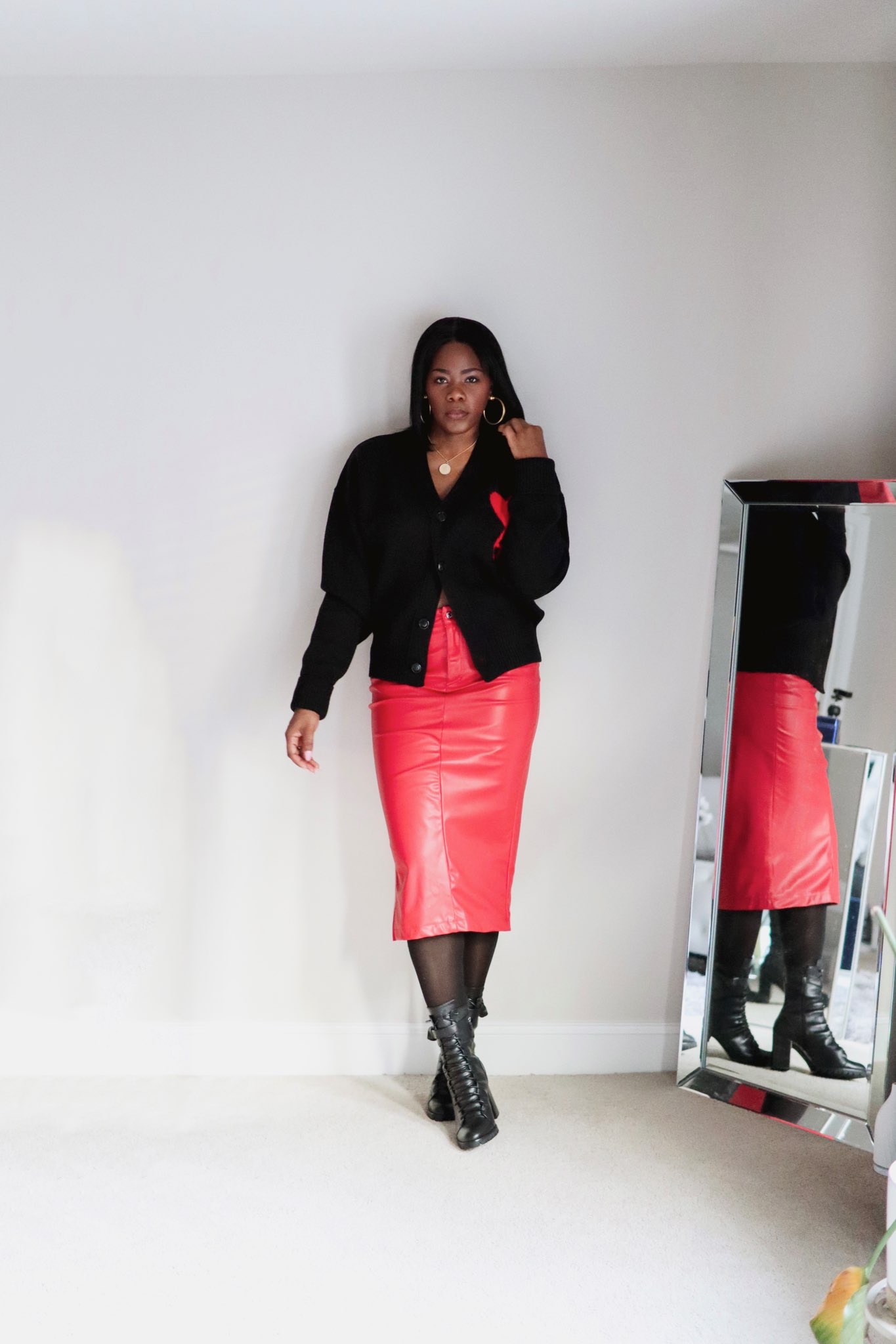 Red leather skirt and black cardigan with a red heart